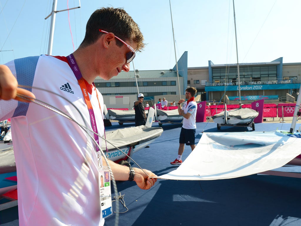 Britain's Stuart Bithell and Luke Patience pack up their boat as light winds prevent sailing for the day in the men's 470 sailing class