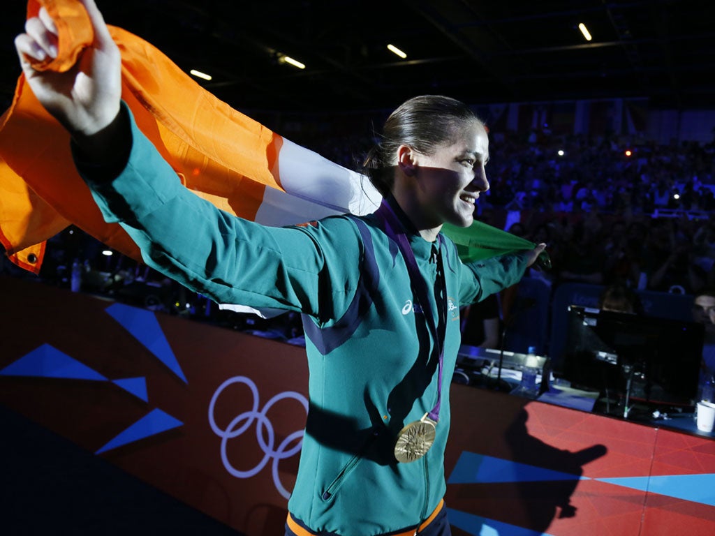 Katie Taylor of Ireland waves her national colors as she celebrates her gold medal victory over Sofya Ochigava of Russia