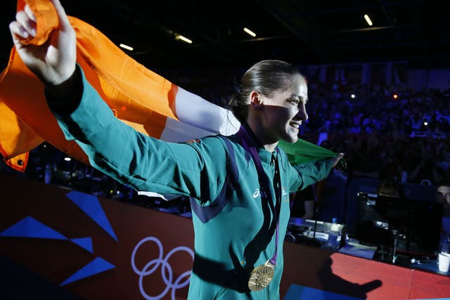 Katie Taylor of Ireland waves her national colors as she celebrates her gold medal victory over Sofya Ochigava of Russia