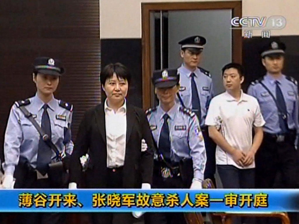 Gu Kailai, second left, being taken into the court in the eastern Chinese city of Hefei yesterday