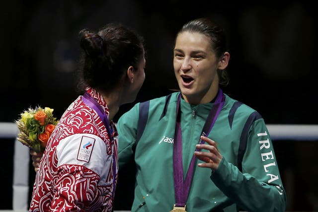 A jubilant Katie Taylor makes the most of the medal ceremony