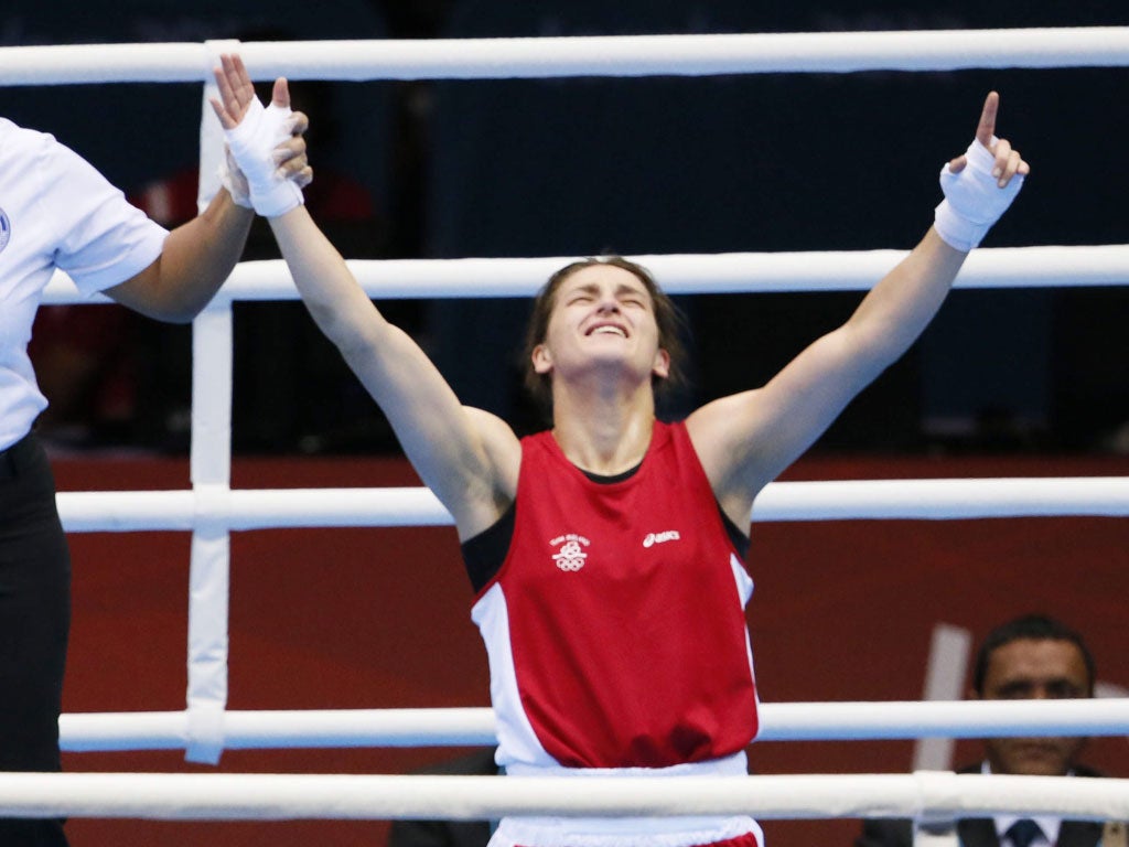 Katie Taylor sinks to the canvas as she is crowned champion