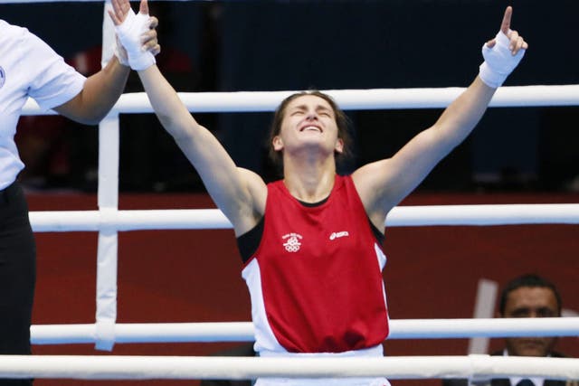 Katie Taylor sinks to the canvas as she is crowned champion