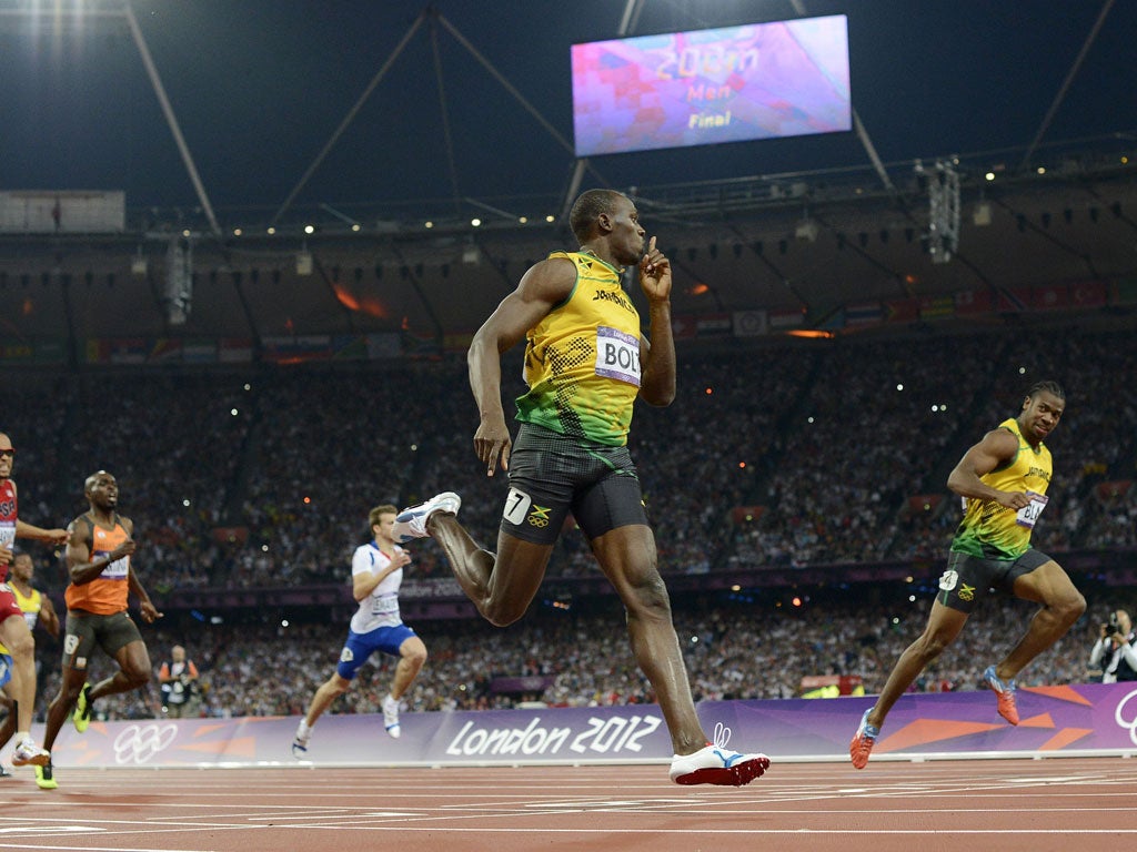 Usain Bolt silences his Jamaican rival Yohan Blake as he becomes the first man to retain the Olympic 200m title