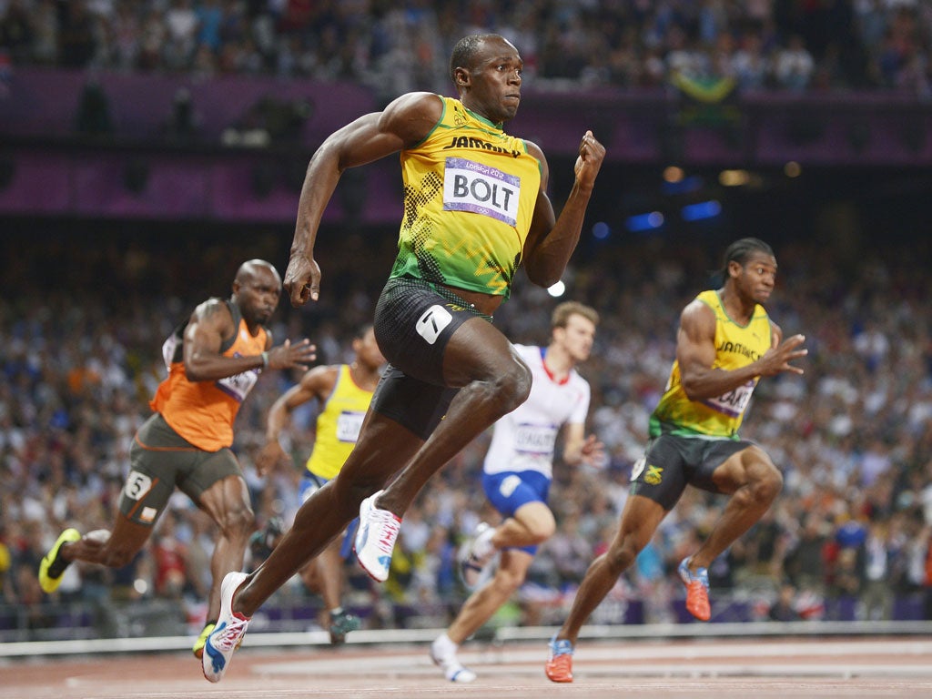Usain Bolt powers to victory in the 200m ahead of compatriot Yohan Blake (right)