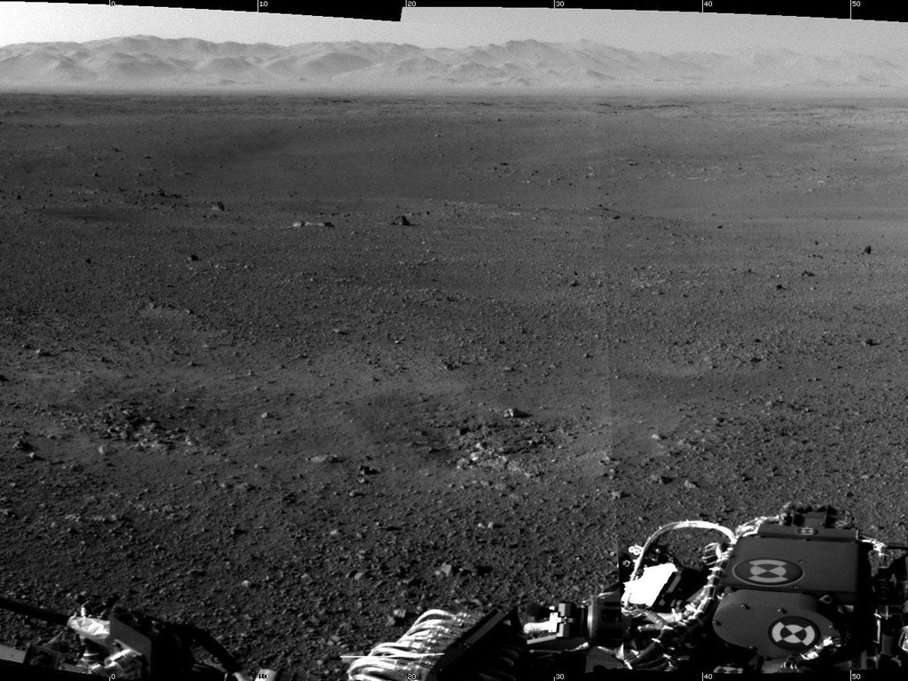 Curiosity's first hi-res image of Mars shows a barren landscape surrounded by hills