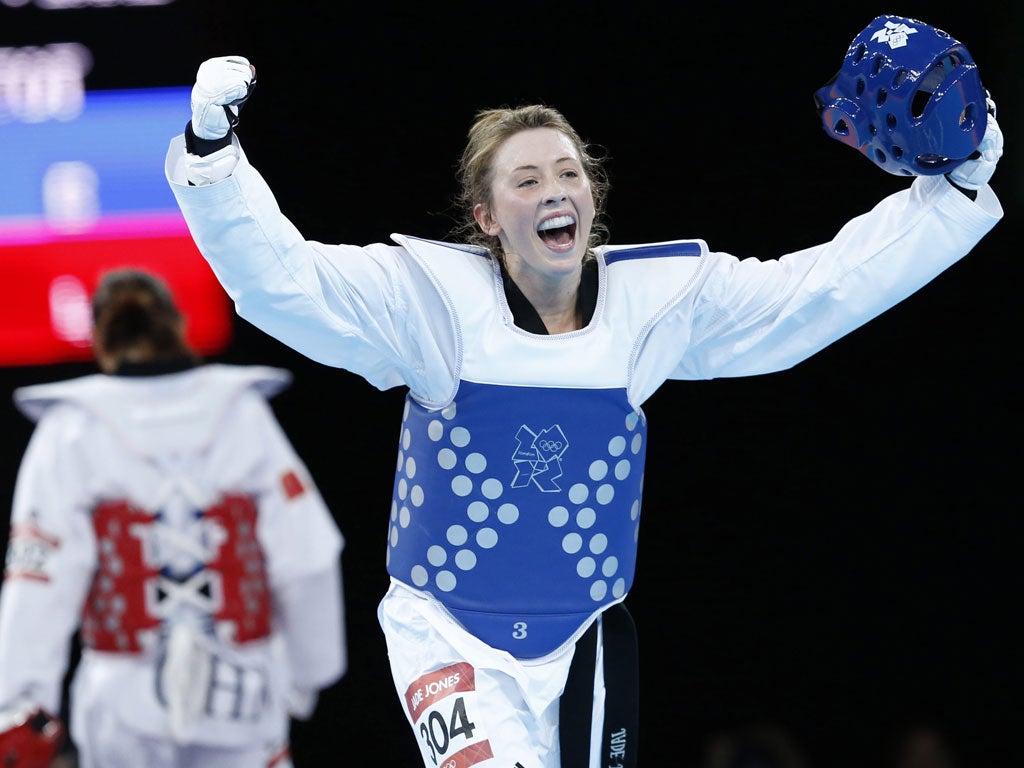 Jade Jones removes her headguard to celebrate winning taekwondo gold last night