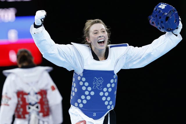 Jade Jones removes her headguard to celebrate winning taekwondo gold last night