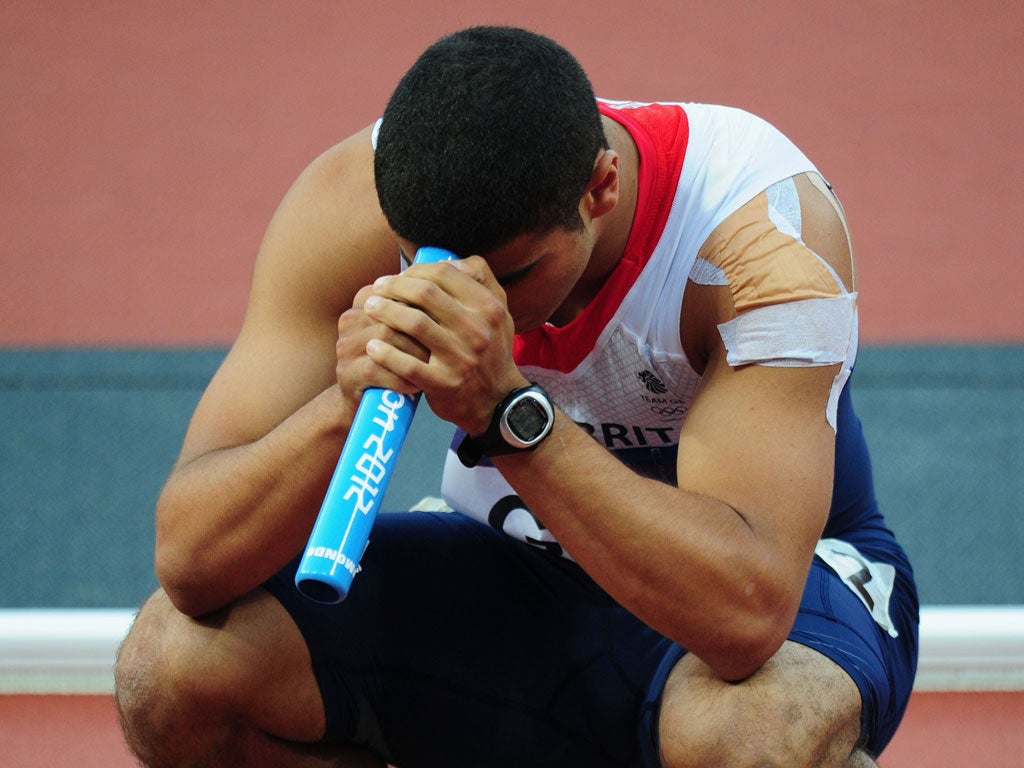 Adam Gemili of Great Britain reacts after the Great Britain team was disqualified during the Men's 4 x 100m Relay Round