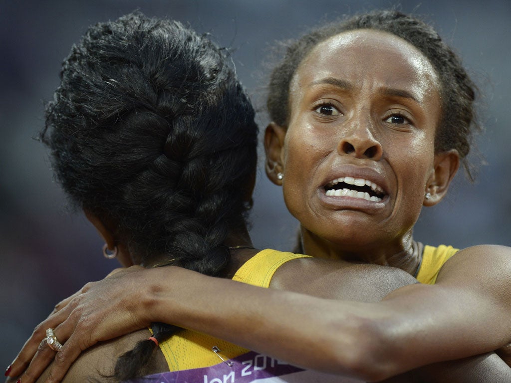 Meseret Defar (right) celebrates her 5,000m win with Tirunesh Dibaba