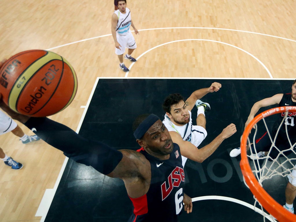 LeBron James goes up for a dunk over Argentina's team yesterday