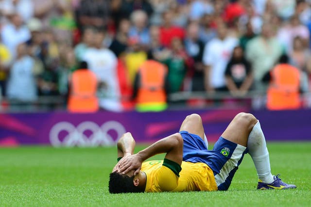 A Brazilian football player is distraught after losing to Mexico in the final