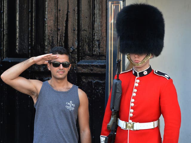 We salute you: A tourist poses for the obligatory photo with a soldier from the Queen's Guards