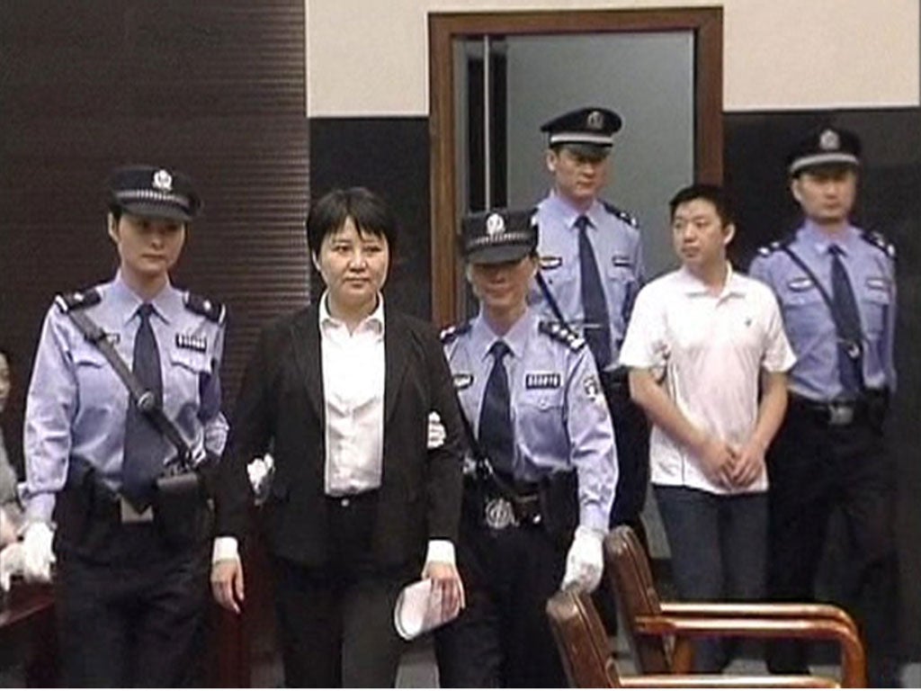 On trial: Gu Kailai, second left, and co-accused Zhang Xiaojun, second right
