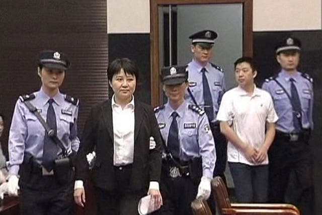 On trial: Gu Kailai, second left, and co-accused Zhang Xiaojun, second right