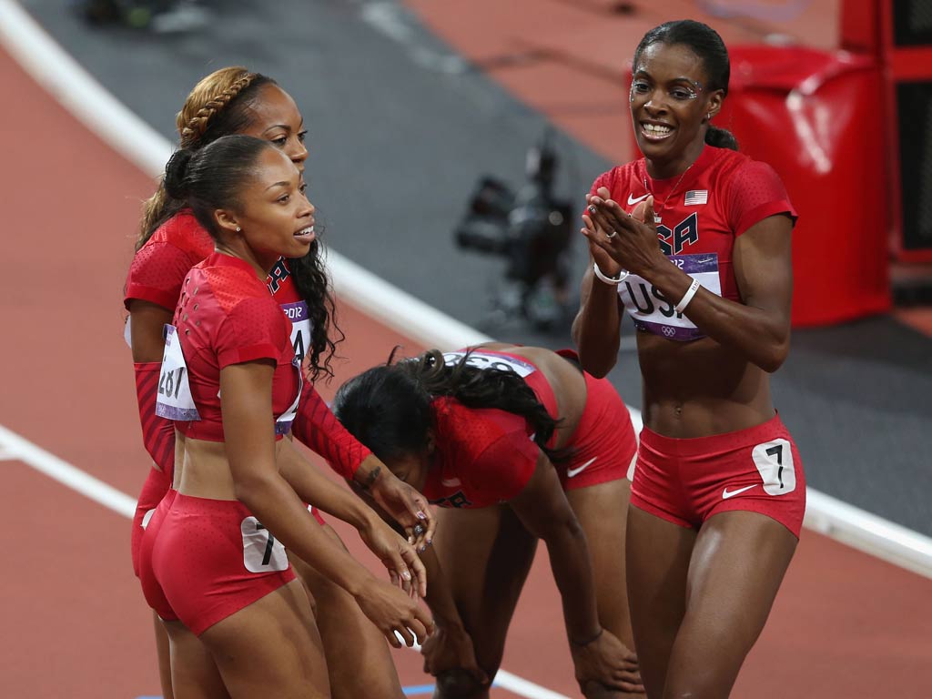 Allyson Felix celebrates her third gold medal of London 2012 with her US relay team-mates