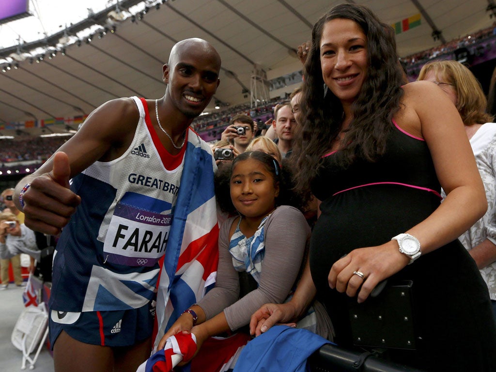Family affair: Mo Farah celebrates his second gold medal with his stepdaughter Rihanna and wife Tanya at the Olympic Stadium