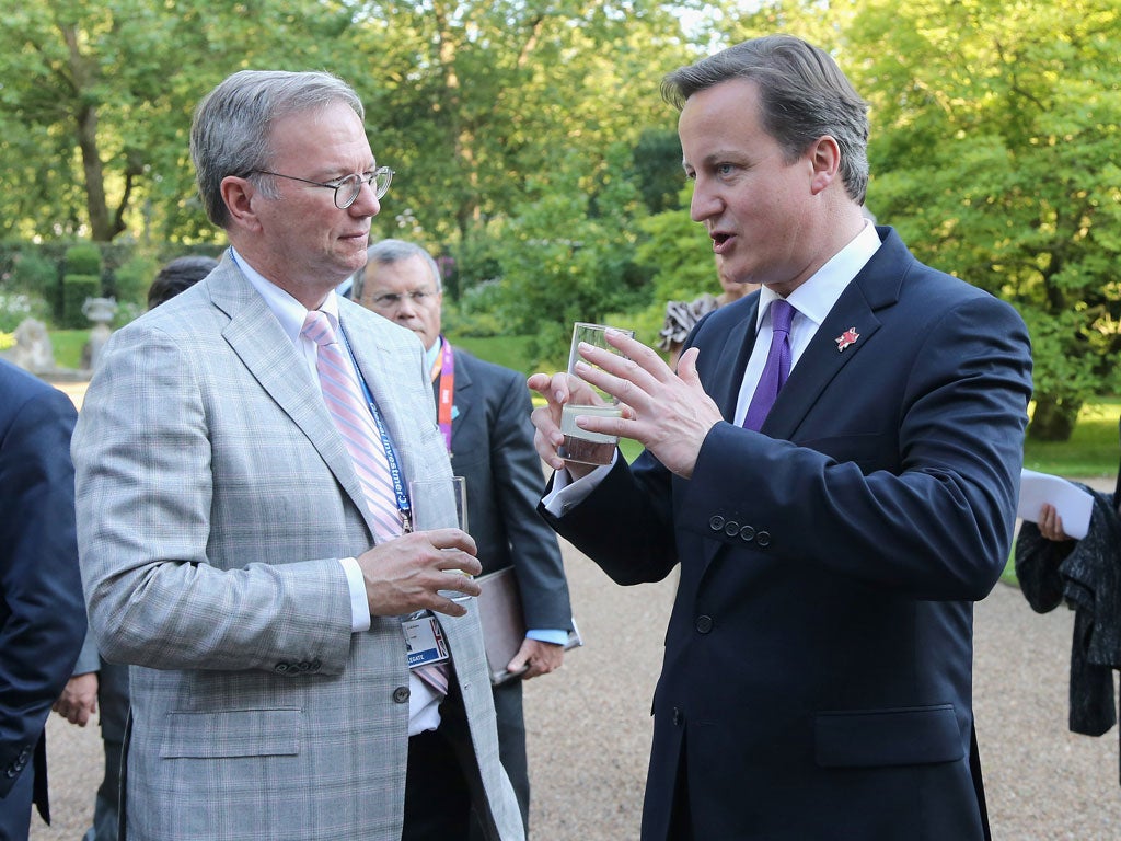 Prime Minister David Cameron (R) speaks with Eric Schmidt of Google