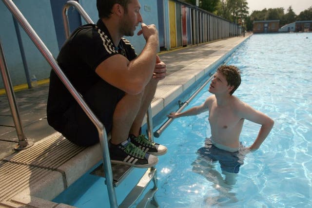 Ian Thorpe, Australian five time Olympic gold medalist swimmer, left, giving swimming lessons to The Independent journalist Kevin Rawlinson at Tooting Bec Lido in London