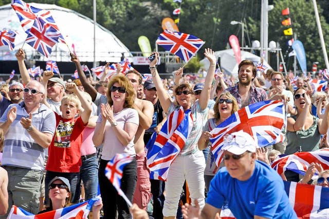 Crowds go wild as they watch Team GB sailor Ben Ainslie win his
fourth Olympic gold on screens at the Weymouth Beach, Dorset