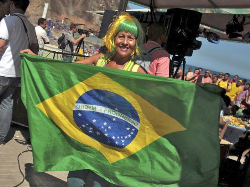 A football fan at Copacabana beach watches Brazil play Mexico in
London