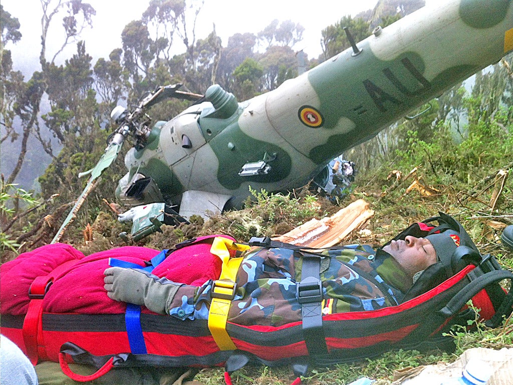 Chris Kasaija, a senior Ugandan Airforce pilot, is rescued from the wreckage of his helicopter
