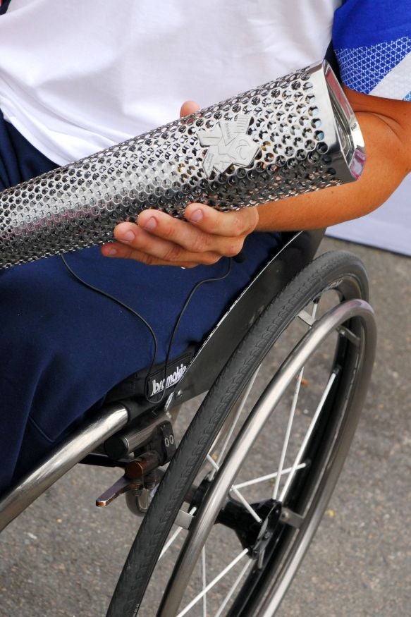 Detail of Great Britain Paralympian David Phillipson holding the 2012 Paralympic Games torch