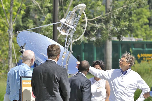 Bill Gates reviews a solar-powered lavatory at the Reinventing the Toilet fair