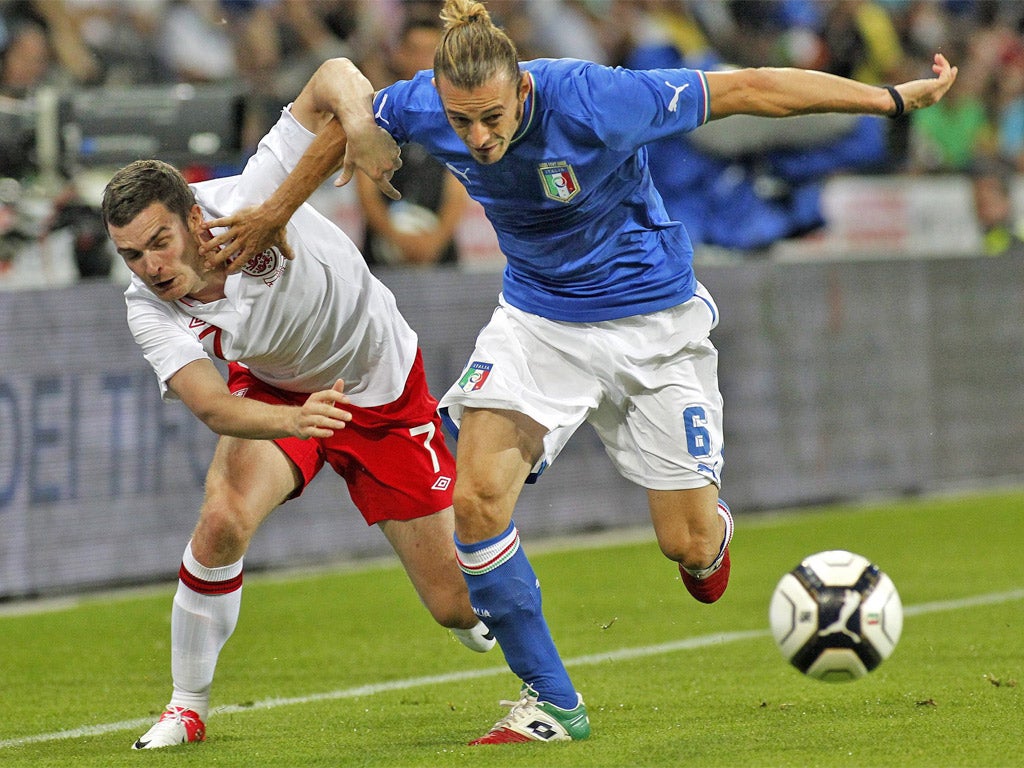 Adam Johnson fights for the ball with Italy’s Federico Balzaretti