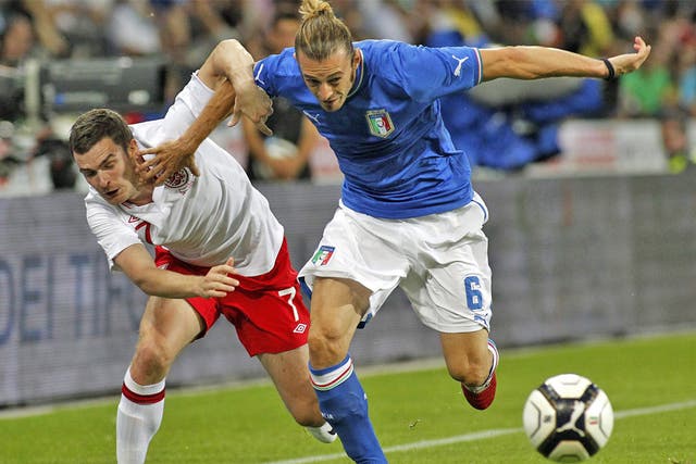 Adam Johnson fights for the ball with Italy’s Federico Balzaretti