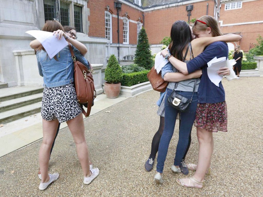 Students embrace after viewing their A-level results outside St Paul's Girls School in London