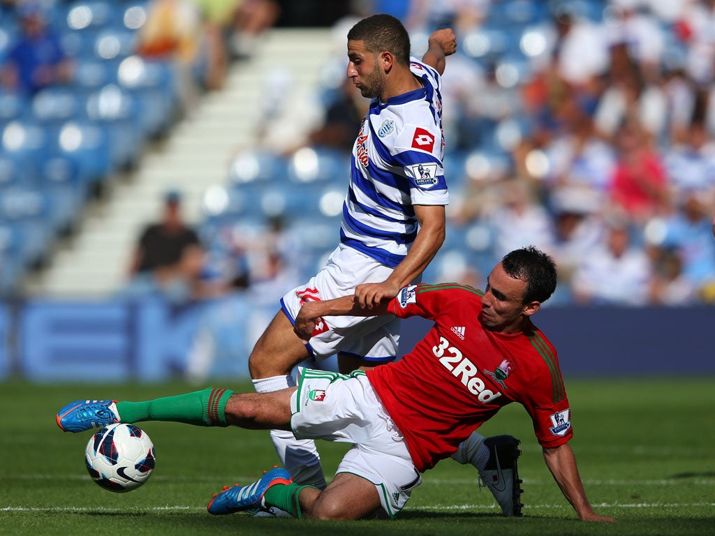Leon Britton of Swansea tackles Adel Taarabt of QPR