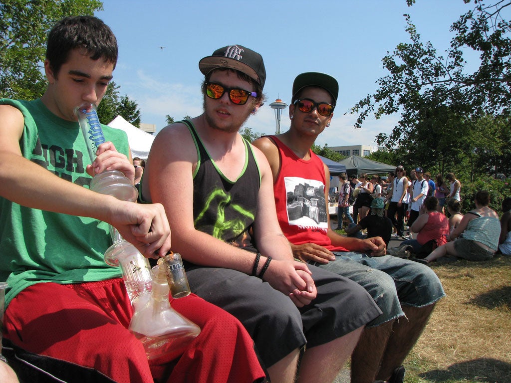 Holy smoke: Festival-goers light a bong at the annual Hempfest