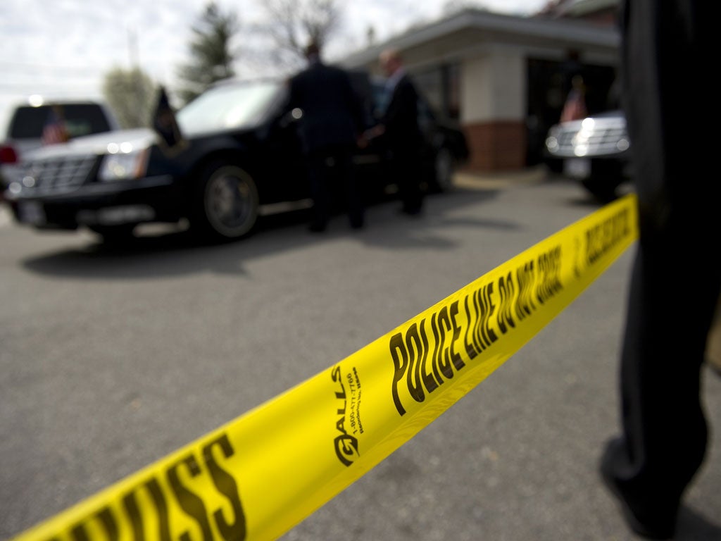 Trigger points: Armed officers surround the President's car