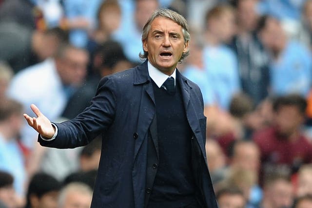 Helping hands: 'We now have 10 days, time is very short,' says Roberto Mancini of City's lack of activity in the transfer window