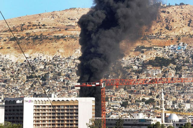 Smoke billows after a bomb on a fuel truck exploded near a Damascus hotel used by the UN, last Wednesday