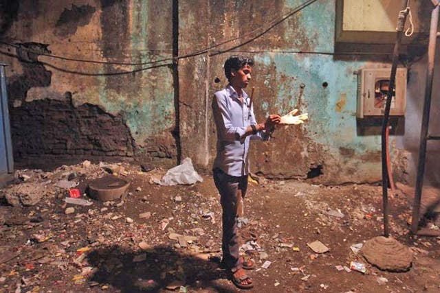 Rat killer Shakeel Sheikh, 24, getting ready for work in Mumbai