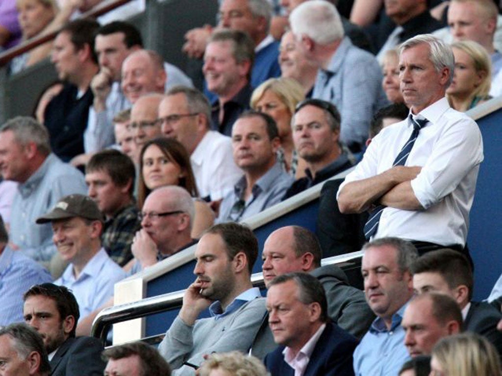 Newcastle manager Alan Pardew watches the game from the stand