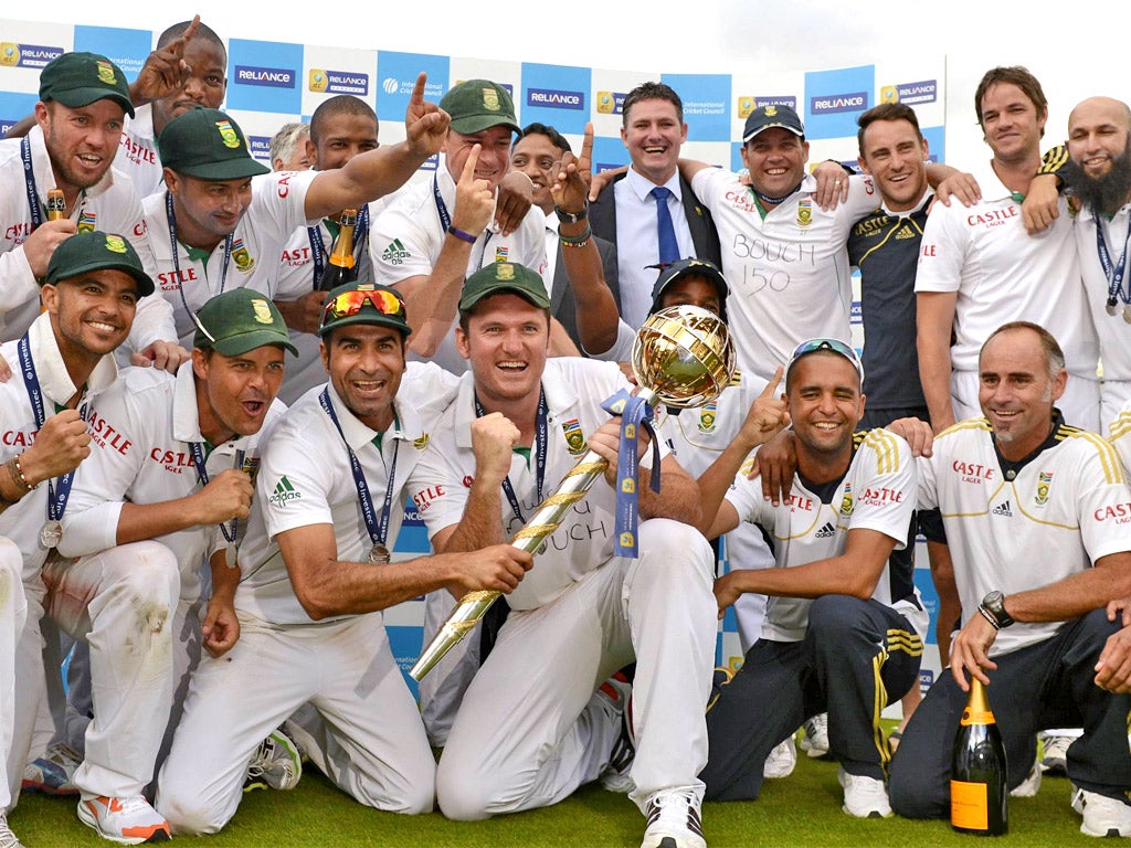 Captain Graeme Smith holds the the ICC mace after surrounded by jubilant South African team-mates