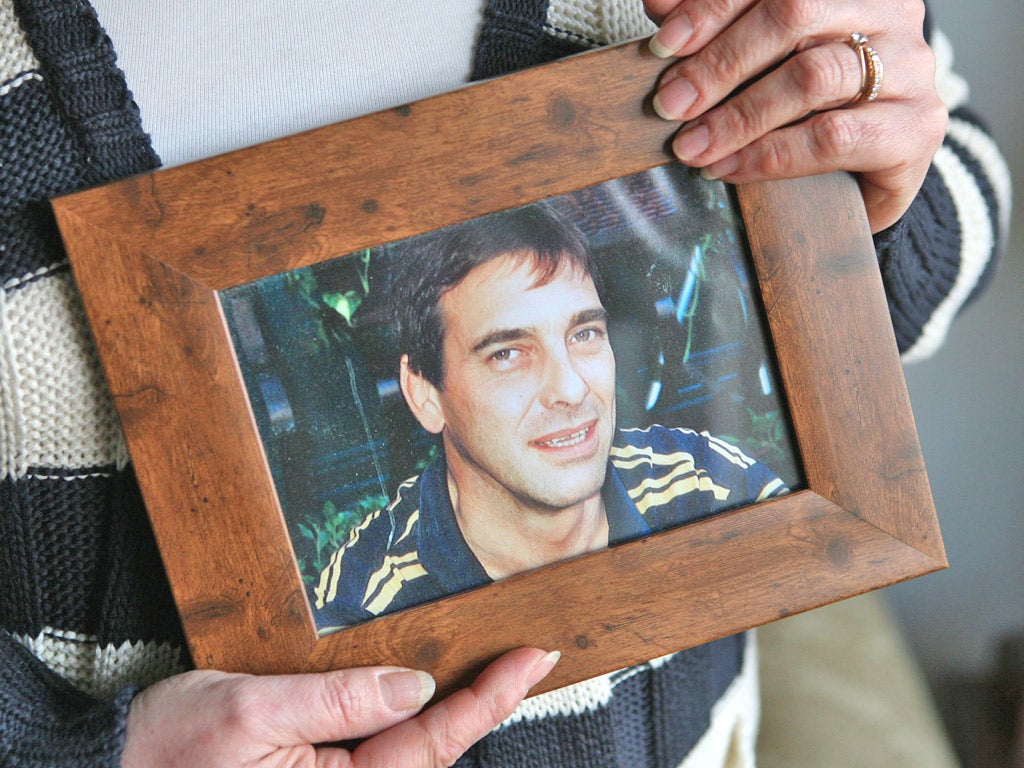Tony Nicklinson's wife, Jane, holds a photograph of her husband before his stroke