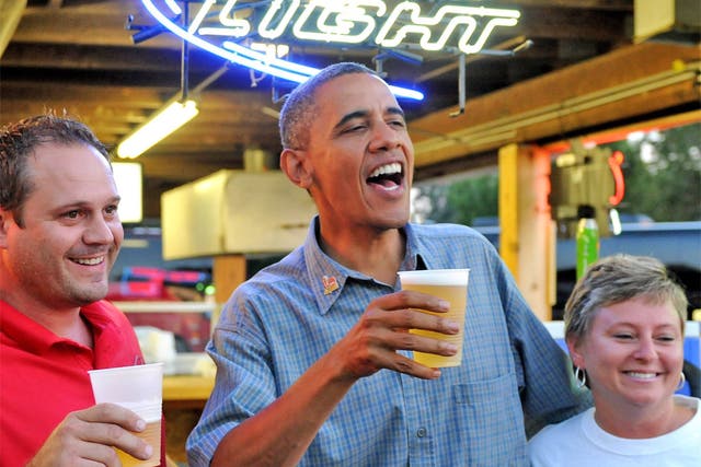 Barack Obama enjoying a beer with locals in Iowa earlier this month