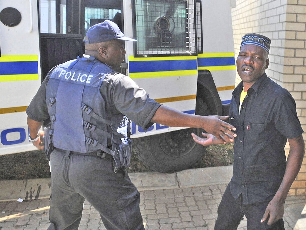 Chris Mahlangu, right, is led away from court after being sentenced