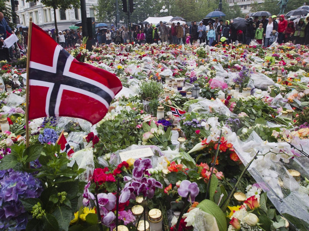 Flags, flowers and candles commemorate the victims of Anders Breivik, in Oslo