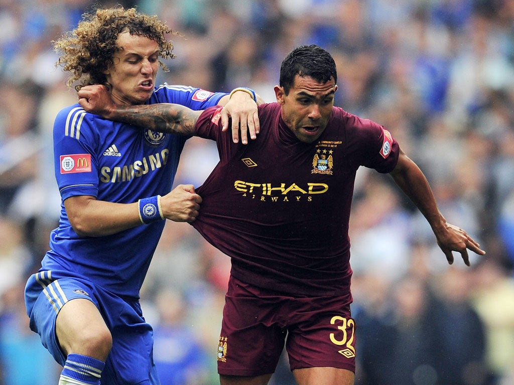 Chelsea defender David Luiz battles with Carlos Tevez during the Community Shield