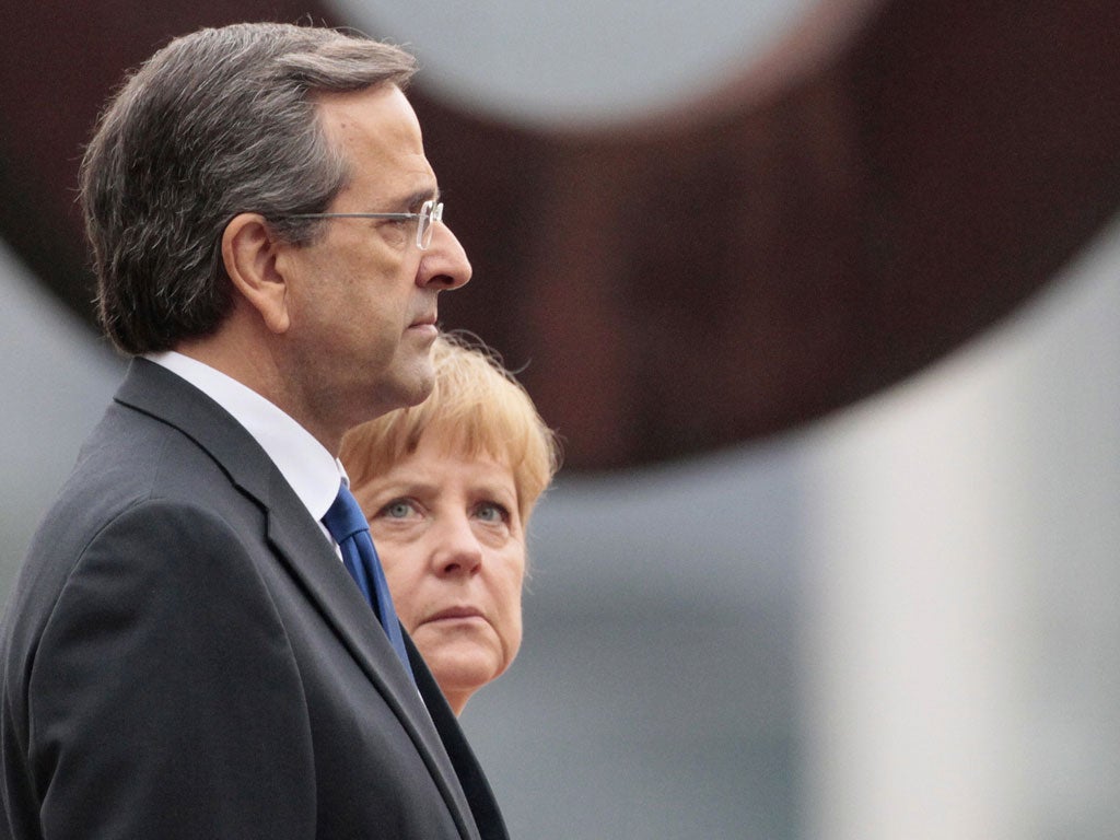 German Chancellor Angela Merkel and Greek Prime Minister Antonis Samaras attend a welcome ceremony in Berlin today