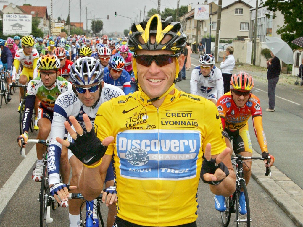 Lance Armstrong signals his seventh win to victory at the Tour de France