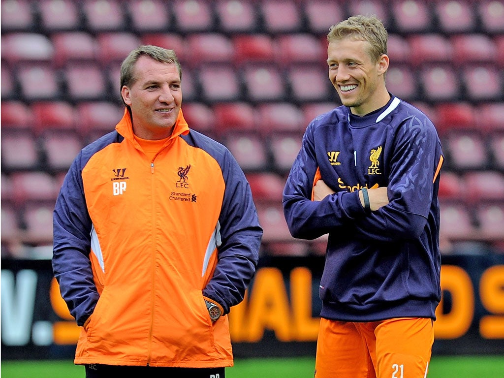 Brendan Rodgers (left) shares a joke with midfielder Lucas