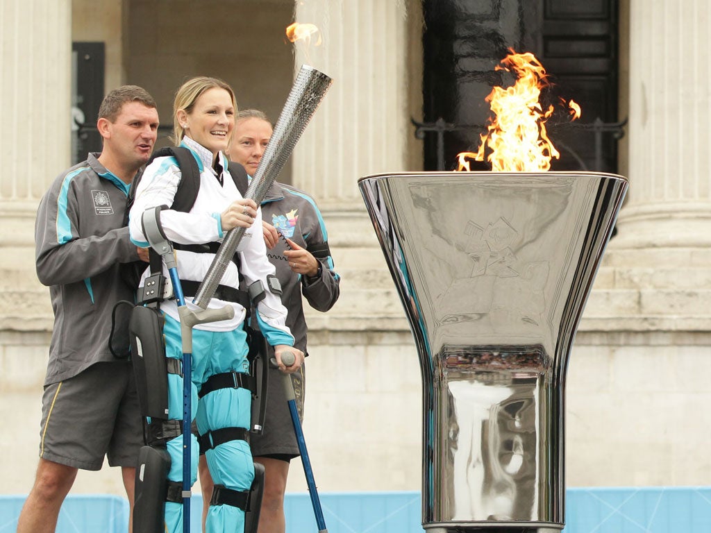Claire Lomas, who completed the London Marathon in a robotic
suit, lights the Paralympic cauldron in Trafalgar Square