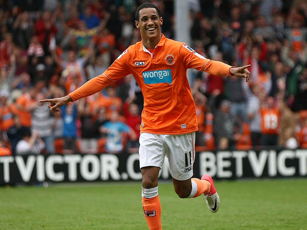 Hit for six: Thomas Ince celebrates his The winner: Luciano Becchio celebrates his brace in Blackpool's rout of Ipswich