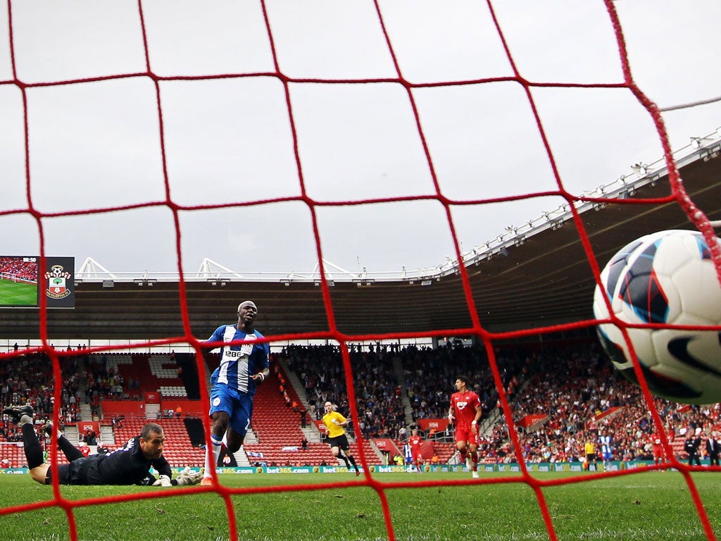 Net loss: Southampton keeper Kelvin Davis watches the ball fly past him as Wigan's Arouna Kone scores on his debut